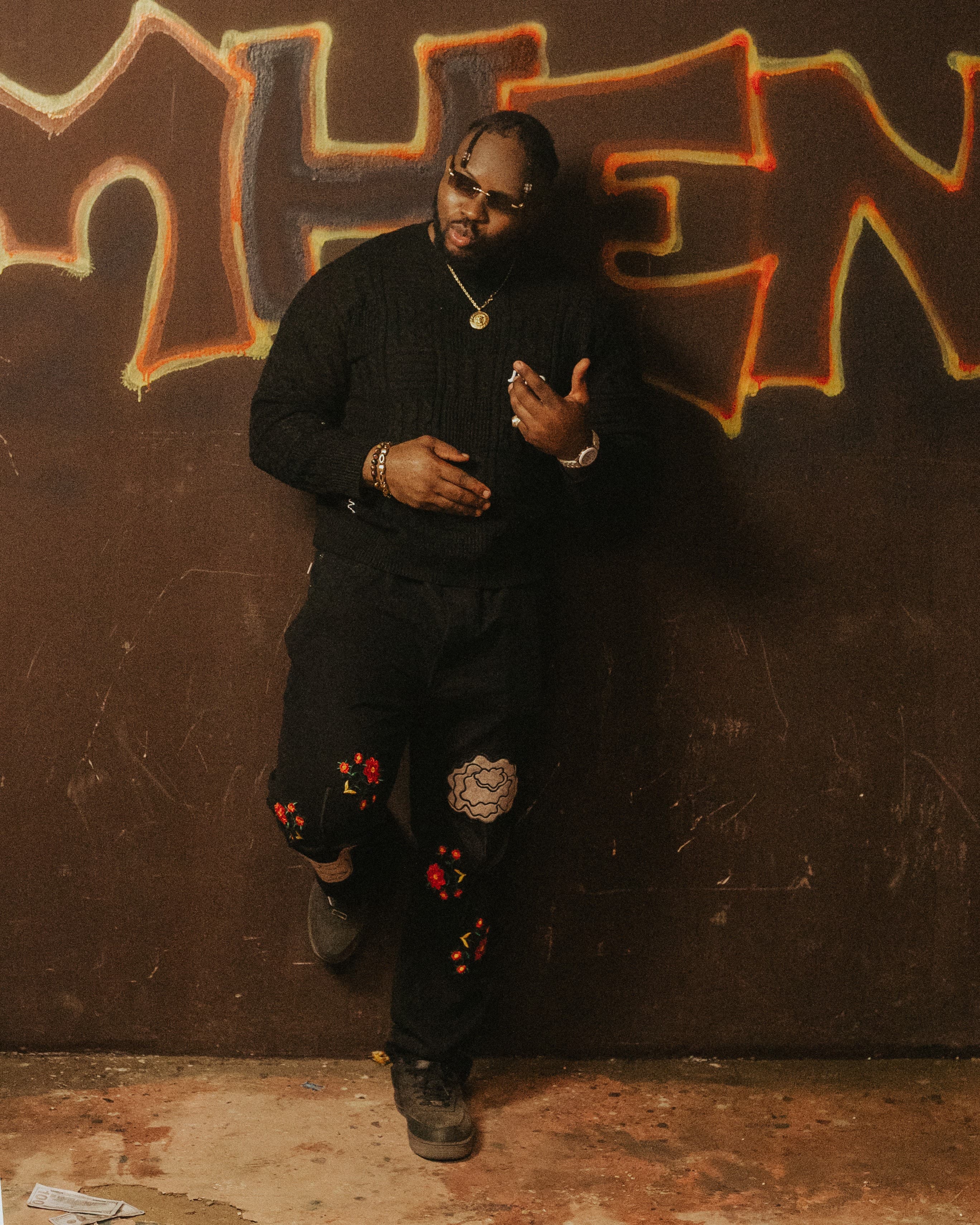 j mula posing with graffiti in background